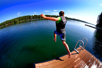 Summer Fun Kids Jumping in Lake from Dock