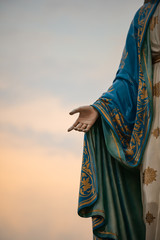 Focus on the hand of the blessed virgin mary,mother of Jesus on the blue sky, in front of the Roman Catholic Diocese, public place in Chanthaburi, Thailand. - obrazy, fototapety, plakaty