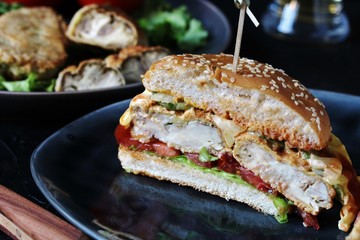 Brain Burger. Fried brains beef, calf or sheep are fried in deep fried as a cutlet in a burger. shows a sandwich in a section. fashionable exotic food. Zombie food. weird food. hipster food