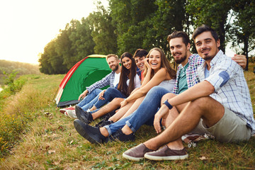 A group of friends on a picnic on the nature.