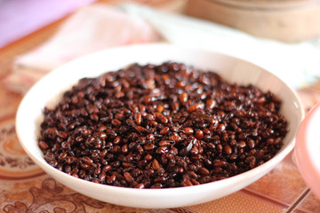 black beans in a bowl on wooden background