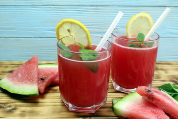 two glasses of watermelon juice with a straw