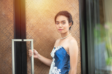Beautiful portrait asian woman dress in blue fashion evening dress act like model and look at camera.