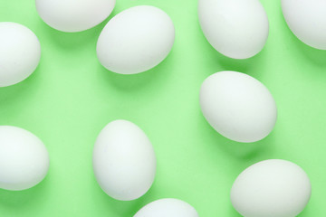 Minimalism food concept. A lot of eggs on green background. Top view