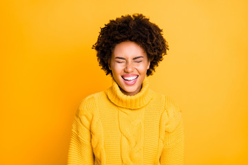 Photo of pretty dark skin lady laughing out loud with closed eyes wear warm knitted jumper isolated yellow color background