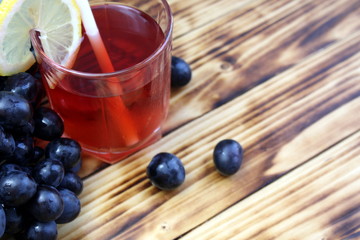 glass of dark grape juice with straws