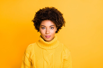 Photo of amazing dark skin lady listening attentively without smile wear warm knitted pullover isolated yellow color background