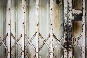 Closed old and rusty accordion shutter