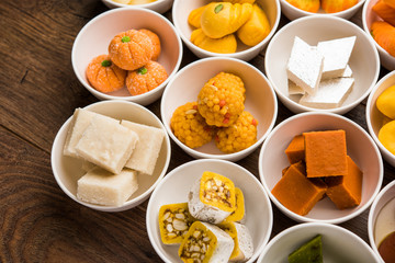 Rangoli of Assorted Indian sweets/mithai in bowl for Diwali or any other festivals, selective focus
