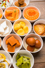 Naklejka na ściany i meble Rangoli of Assorted Indian sweets/mithai in bowl for Diwali or any other festivals, selective focus