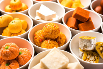 Rangoli of Assorted Indian sweets/mithai in bowl for Diwali or any other festivals, selective focus