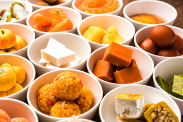Rangoli of Assorted Indian sweets/mithai in bowl for Diwali or any other festivals, selective focus