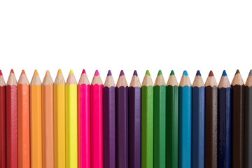 Colored pencils of various colors on a white background