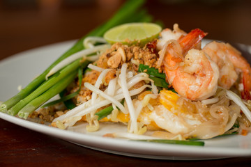 Rice noodles with shrimps and vegetables close-up on the table. top view of a horizontal