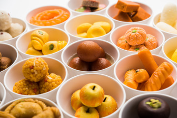 Rangoli of Assorted Indian sweets/mithai in bowl for Diwali or any other festivals, selective focus