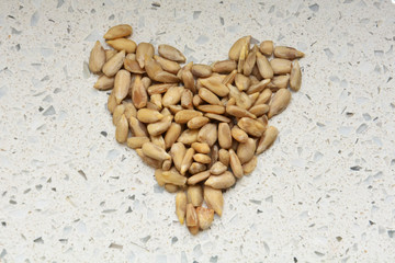 Peeled sunflower seeds in the shape of a heart