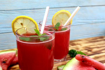 two glasses of watermelon juice with a straw
