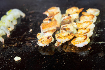 Shrimps on the roasted pan, sea food barbecue on the black background