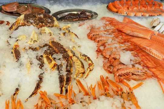 Salmon Fish, Crab Legs And Shrimps, Sea Food On The Ice