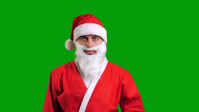 Santa Claus in red suit wag hand palm on green chroma key background. Christmas and New Year celebration concept