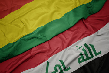 waving colorful flag of iraq and national flag of bolivia.