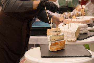 Woman Serving Fresh Cheese At Farmers Food Market