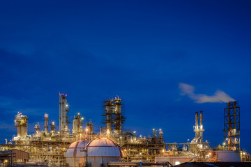 Fototapeta na wymiar Oil and gas refinery plant or Petrochemical industrial plant on blue sky twilight background, Glitter lighting factory of petroleum plant with dawn sky