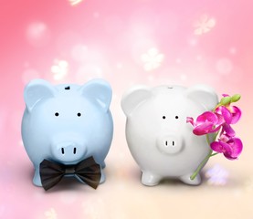White and blue piggy banks on table on background