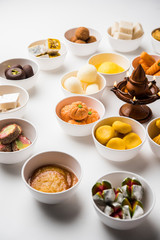 Rangoli of Assorted Indian sweets/mithai in bowl for Diwali or any other festivals, selective focus