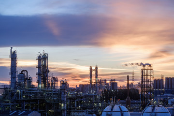 Oil and gas refinery plant or petrochemical industry on sky sunset background, Manufacturing of petroleum industrial plant with distillation tower and smoke stacks
