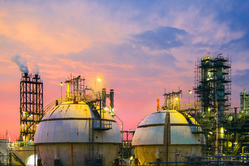 Petrochemical plant on sunset sky background with gas storage sphere tanks, Manufacturing of petroleum industrial, Close up equipment of Gas and oil refinery industrial plant
