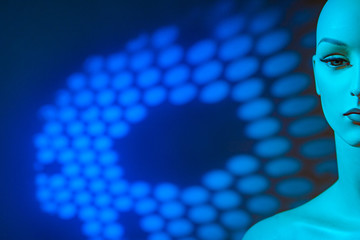 Girl-mannequin on a blue background with an image. Place for inscription. Robot girl. Cyborg. Man of the future. Fiction. Robotics. Artificial intelligence. © Grispb