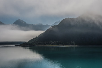 Remote Alaskan coastal landscape on a calm, foggy morning