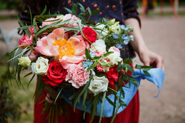 Florist girl collects a large beautiful bouquet. Floristic concept, business concept, gift, surprise, peonies, roses, carnations