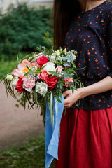 Florist girl collects a large beautiful bouquet. Floristic concept, business concept, gift, surprise, peonies, roses, carnations