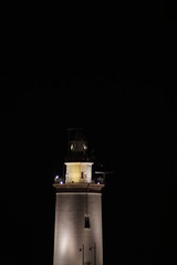 vistas nocturnas de farola y puerto  de malaga con luna llena  andalucia 
