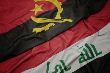 waving colorful flag of iraq and national flag of angola.