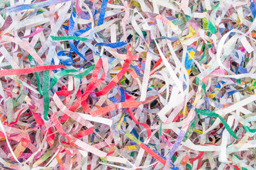 Closeup shredded paper texture and reuse colorful paper scrap background. Selective focus image.