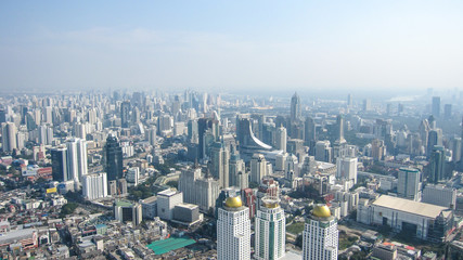 Fototapeta premium high houses of the big city of Bangkok on a clear sunny day, blue sky above them, aerial view