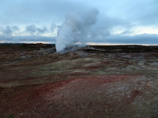 Mud pools with thick steam rising from the ground in Gunnuhver, south-west Reykjanes, Iceland