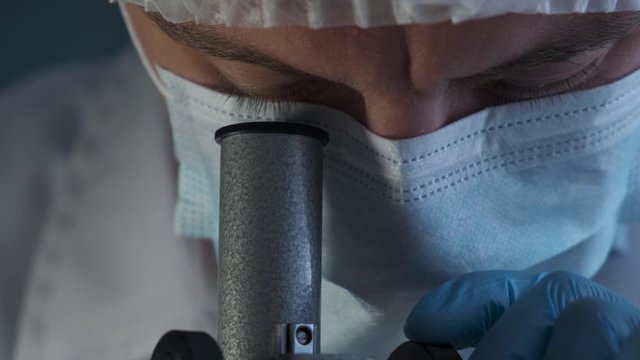 Close-up of a scientist using microscope in a laboratory
