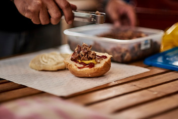 hamburger being prepared on a table