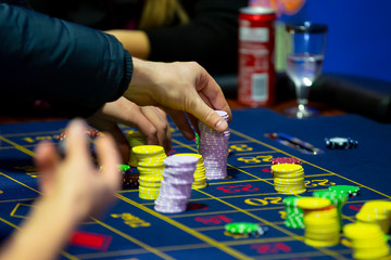 Roulette table in casino human hands