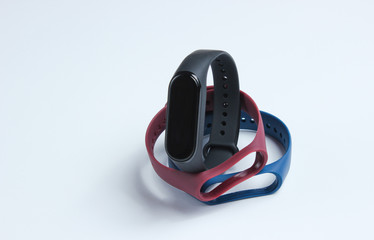 Fototapeta premium Smart watch with interchangeable bracelets on white background. Fitness tracker. Modern gadgets