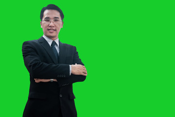 Successful Asian businessman standing and arms crossed confidential, business man smiling on green screen studio.