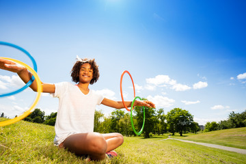 Cute young girl with curly hair rotate hoops