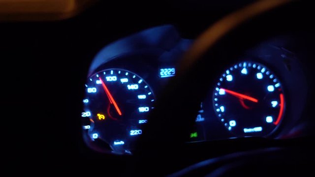 Closeup dashboard of mileage car,speed number, driving at night