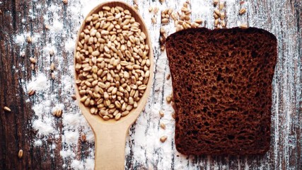 Bread composition on a table with grain and flour. Bread, grain and flour on the table.