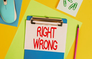 Word writing text Right Wrong. Business photo showcasing choose between two decisions correct and bad one to make Clipboard striped sheets marker clips notepad mouse colored background