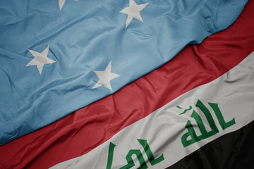 waving colorful flag of iraq and national flag of Federated States of Micronesia .
